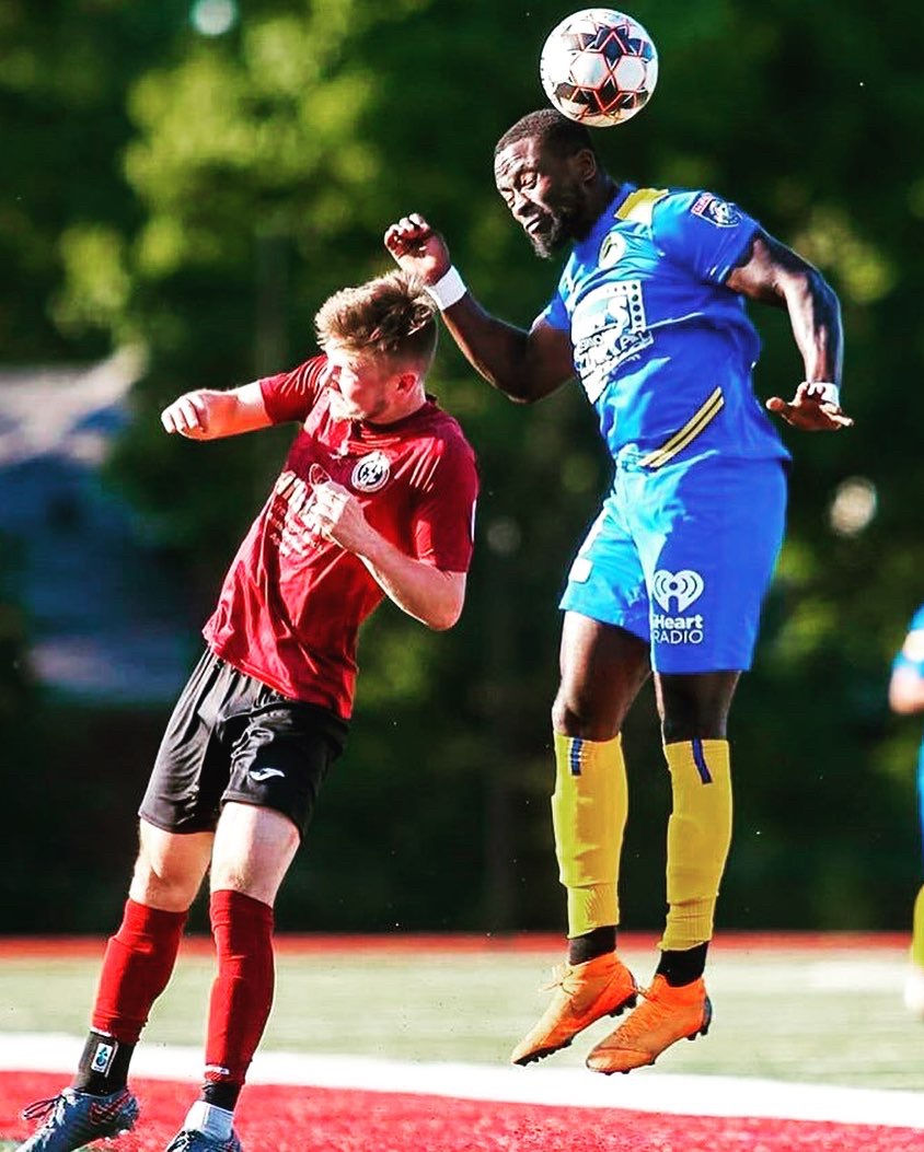 Isaac Kissi rising for a header during a professional match